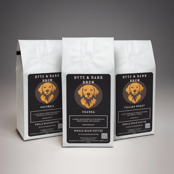 Three white coffee bags displaying Byte & Bark Brew® black labels with a golden dog logo, front view
