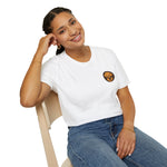 Smiling model seated in white crewneck t-shirt with small round dog emblem on left chest