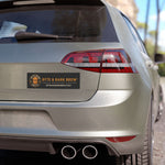 Silver hatchback rear with rectangular Byte & Bark Brew® black car magnet centered on lower trunk