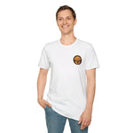 Smiling male model wearing white crewneck t-shirt with small circular brown-and-orange dog logo on left chest