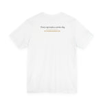 White t-shirt back with centered text 'Every cup trains a service dog.' and website URL below