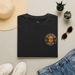 Folded black crewneck t-shirt with Byte & Bark Brew® circular golden retriever logo in flatlay