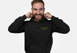 Smiling model adjusting hood on dark charcoal pullover hoodie with lime-green Byte & Bark Brew® logo