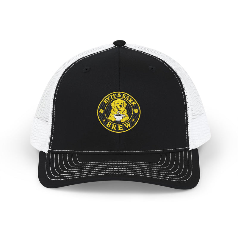 Front view of black and white trucker cap with embroidered Byte & Bark Brew® golden retriever patch
