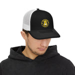 Black front trucker cap with white mesh back and yellow Byte & Bark Brew® patch