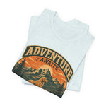 Folded light heather short-sleeve tee showing partial circular vintage mountain and dog graphic