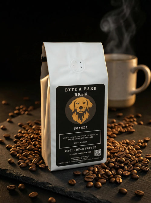Byte & Bark Brew® Uganda whole-bean coffee bag front view with scattered beans and steaming mug