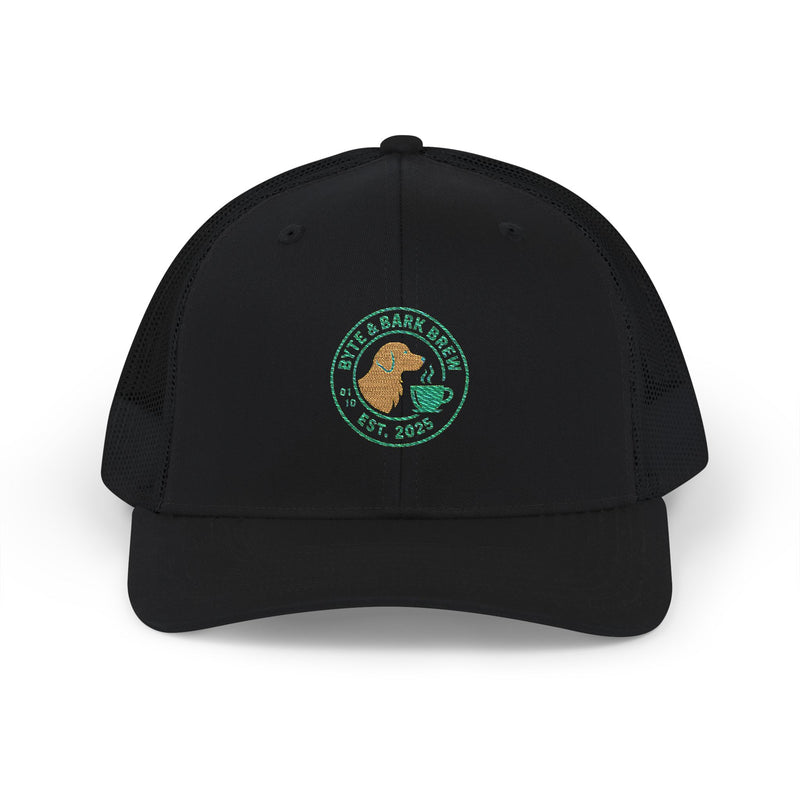 Top-front of black trucker hat with embroidered Byte & Bark Brew® circular dog and cup logo