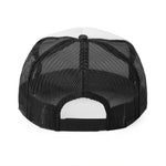 rear view of black mesh trucker cap with white top panels and adjustable snapback