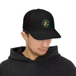 Black trucker hat with mesh back and embroidered Byte & Bark Brew® circular dog logo