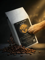 White Byte & Bark Brew® Uganda coffee bag angled with dog paw touching label and scattered beans