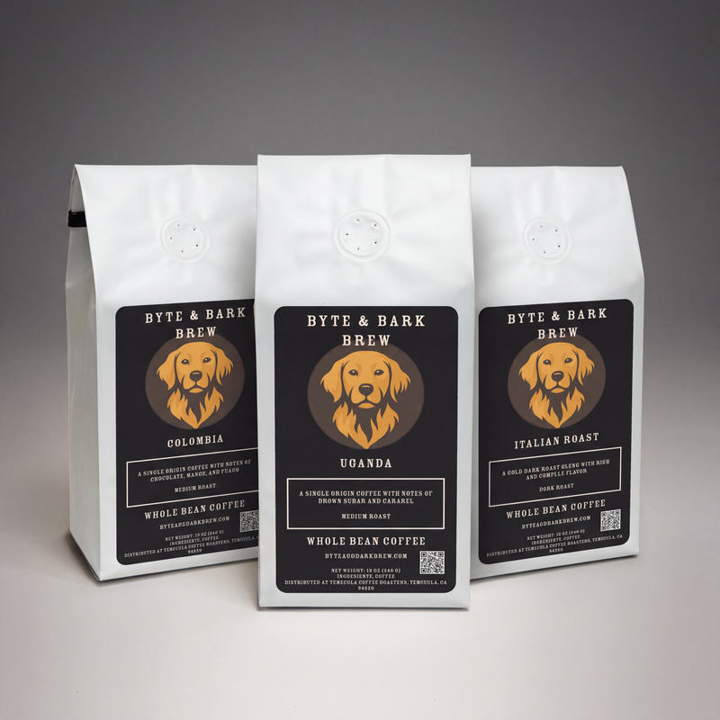 Three white coffee bags displaying Byte & Bark Brew® black labels with a golden dog logo, front view