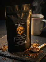 Black resealable Byte & Bark Brew® instant coffee pouch with dog logo, spoon of granules and steaming mug