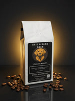 White standing coffee bag labeled Byte & Bark Brew® Italian Roast with roasted coffee beans scattered