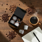 Open black box of Byte & Bark Brew® single-serve pods beside scattered coffee beans, steaming mug, notebook